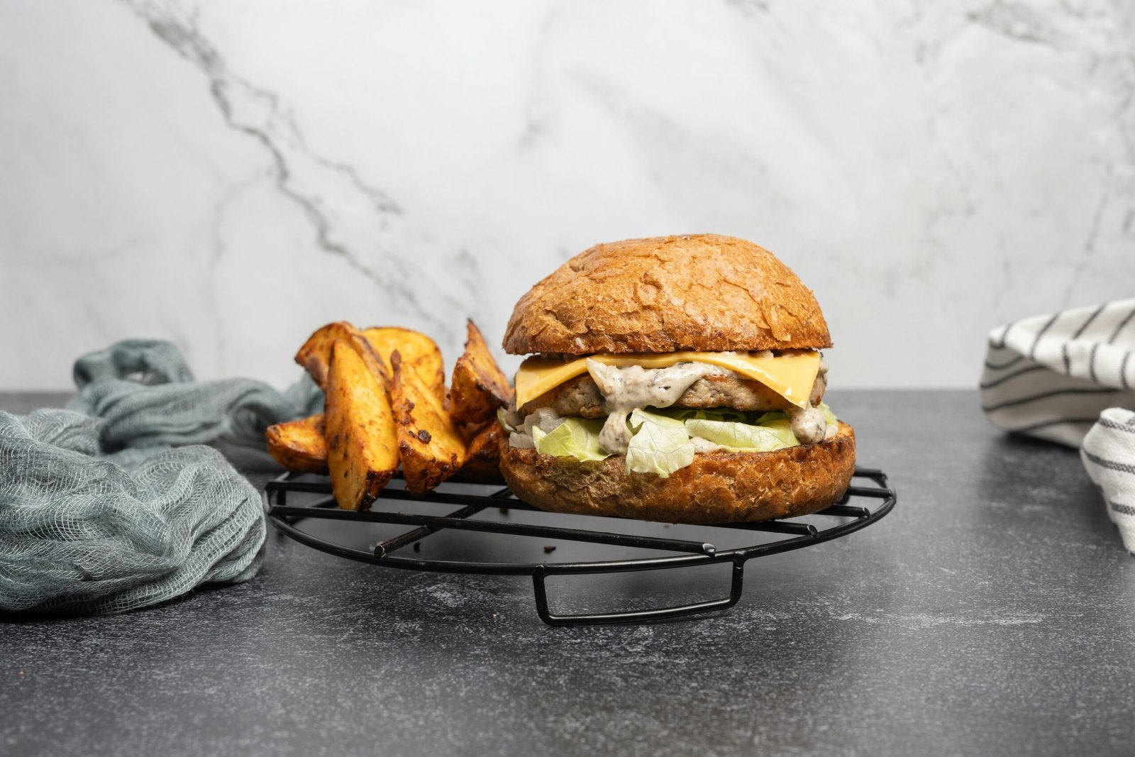 a burger with a side of fries on a cooling rack